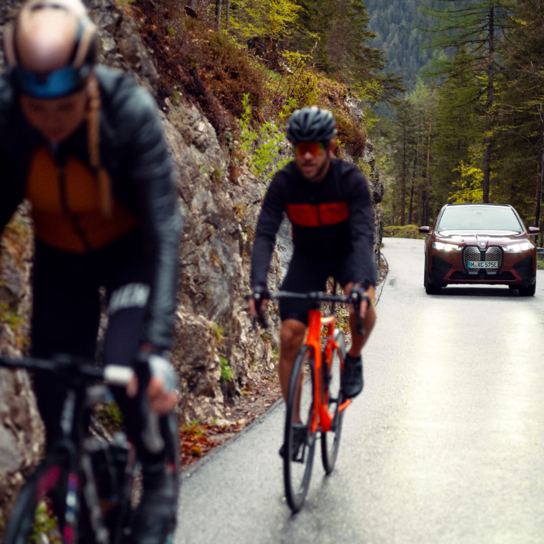 Two cyclists and the BMW iX go for a test spin